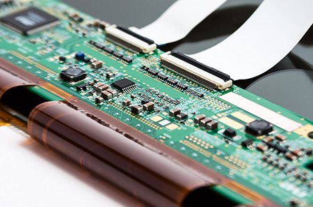 Ribbon cable connection to a printed circuit board