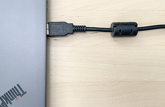 A USB cable with a ferrite core on it