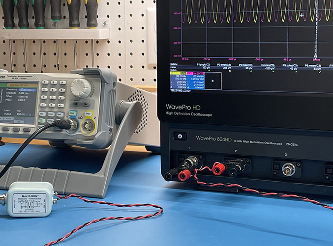 waveform generator driving two channels of an oscilloscope through a balun