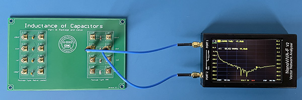 NanoVNA connected to test fixture and displaying S21